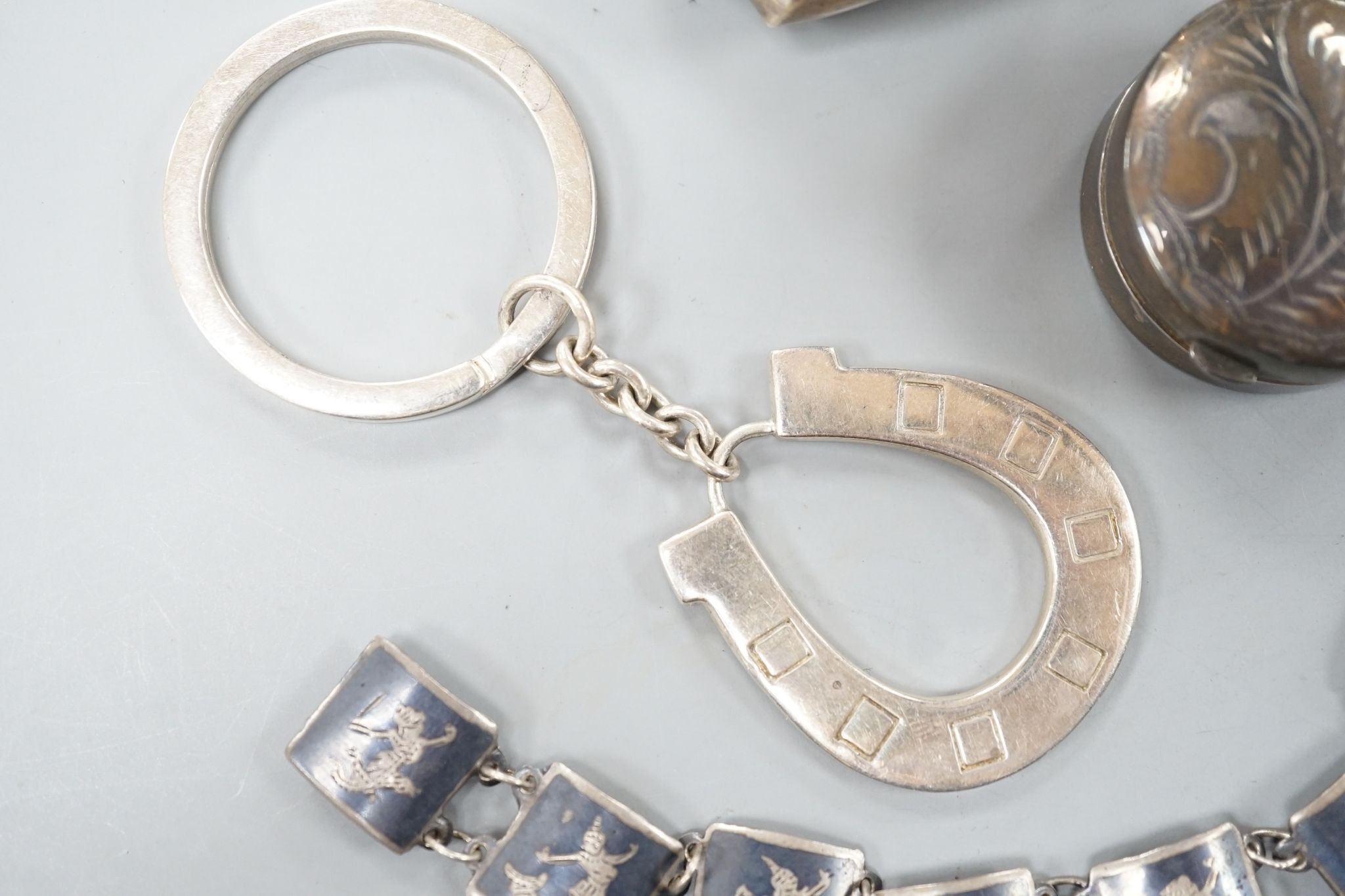 Three silver pill boxes, a key ring and white metal and niello bracelet.